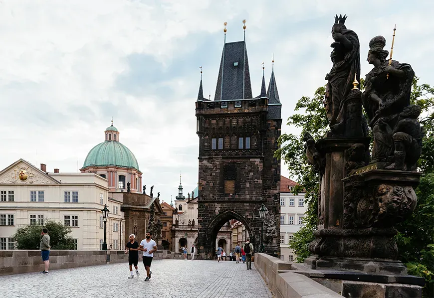 Charles bridge at sunrise with people prague summer in europe